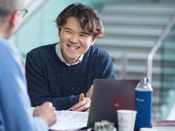 Smiling male student at table