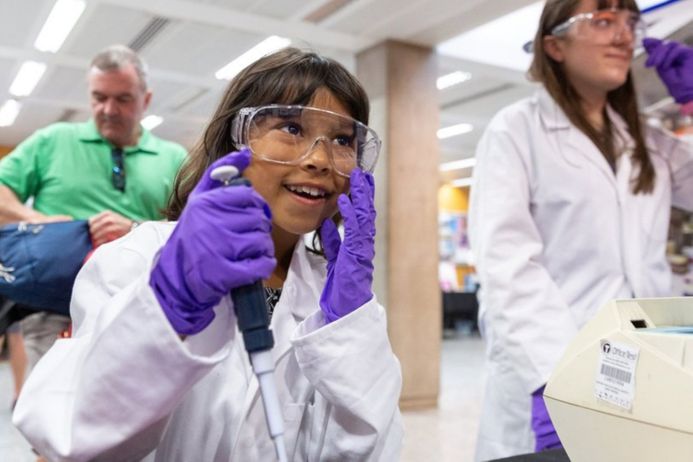 A child has a go at being a scientist at an engagement event