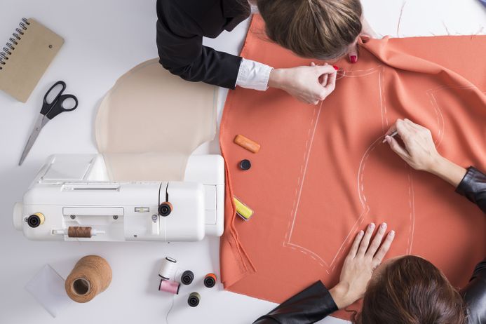 two people making cloths patterns