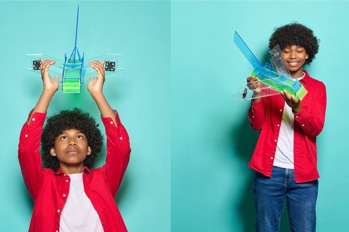 A boy holds up a prototype