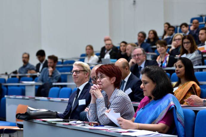 Men and women sitting in a lecture theatre