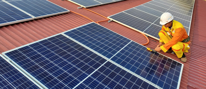 A Male Solar Technician Installing a Solar Panel