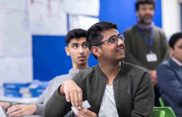 A student looking up at the lecturer during an Outreach session.