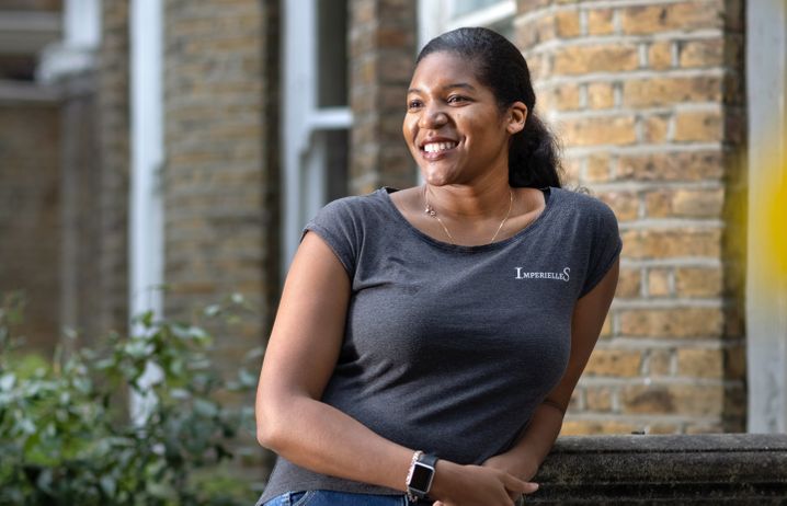 Alicia Gayle leaning against the entrance to her home