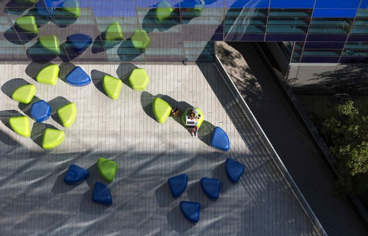 Green and blue seats outside Faculty Building