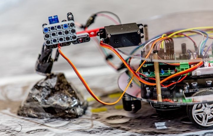 A wheeled miniature lunar explorer running off a circuit board