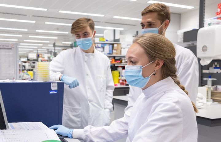 three researchers in a lab