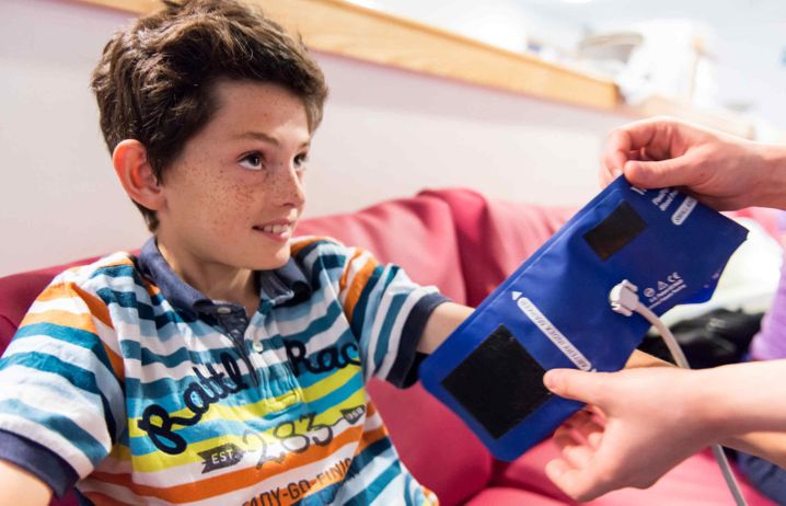 Child wearing a blood pressure cuff