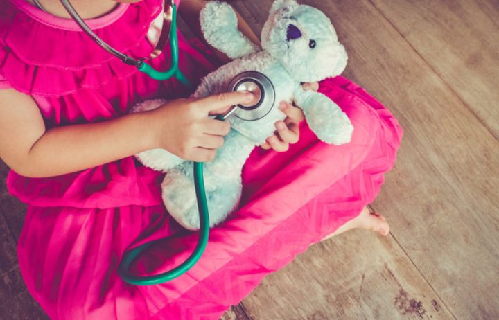 Child playing with a teddy bear