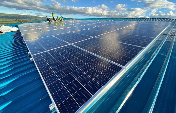 people installing solar panels on a roof