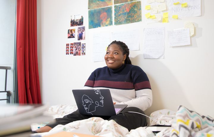 Student on laptop in her Halls room