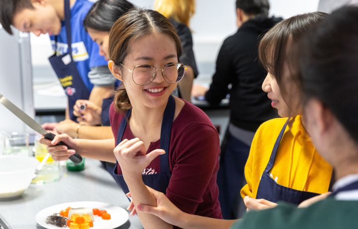 Students cooking and laughing