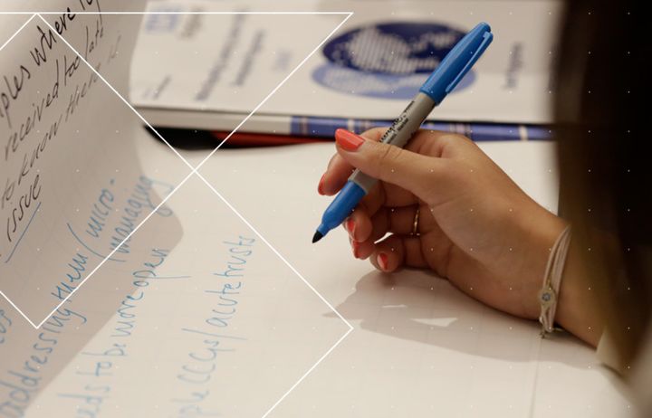 Woman making notes in discussion