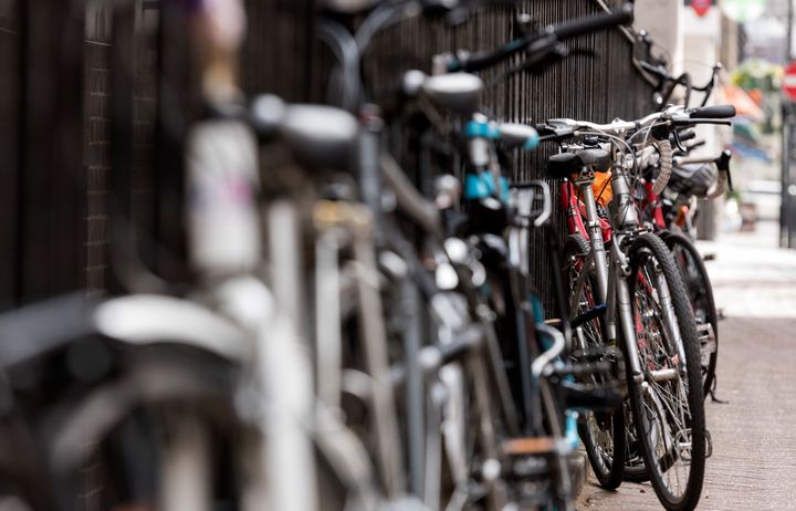 Bikes leaning against a railing