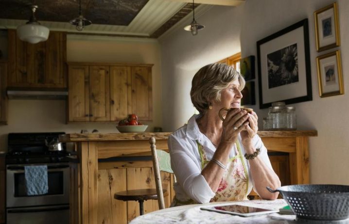 Woman holding mug in her home