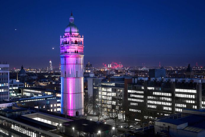 Queens Tower lit up at nighttime