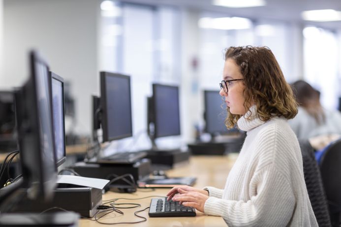 A student sat a computer in the library