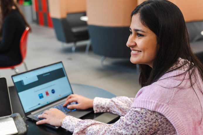 Student sat working at a laptop