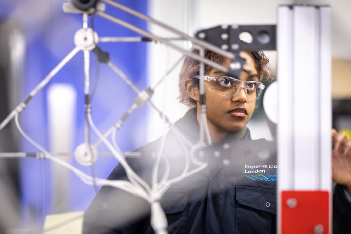 a student behind a modular structure