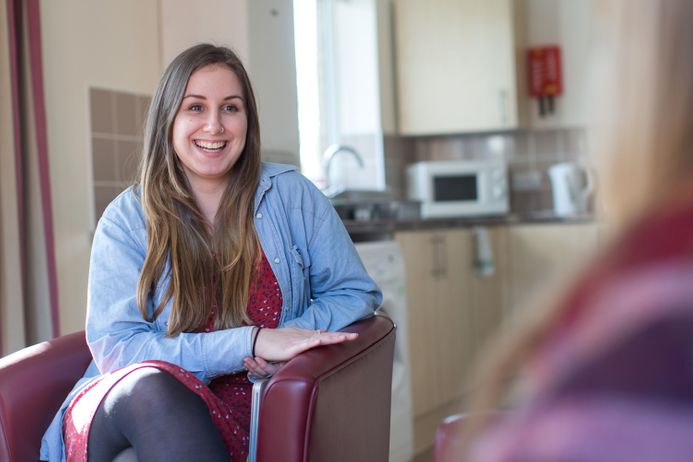 Student sitting on chair smiling