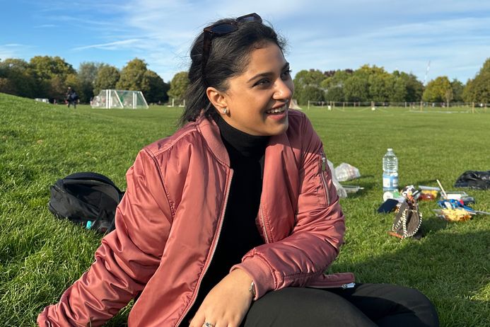 portrait of Rania, a physics student sitting in the park