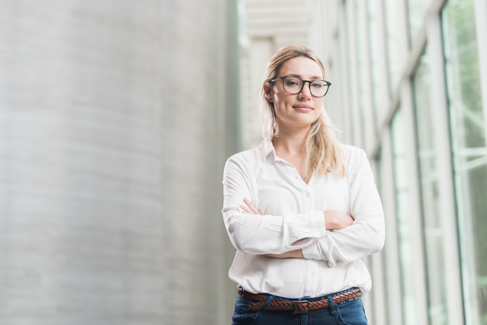 portrait of a female student, wearing glasses with arms crossed