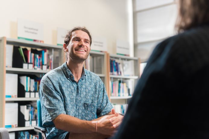 portrait of a male student speaking with another