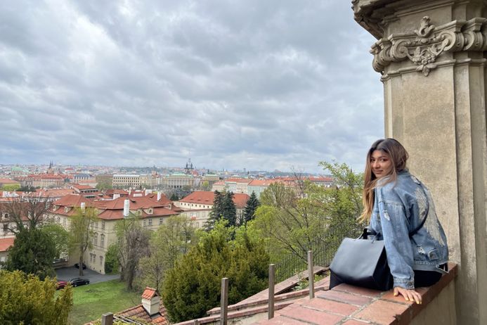 portrait of a female student in front Prague cityscape