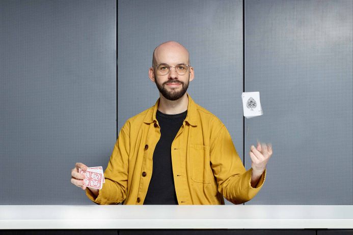Will Houstoun throws a playing card up into the air
