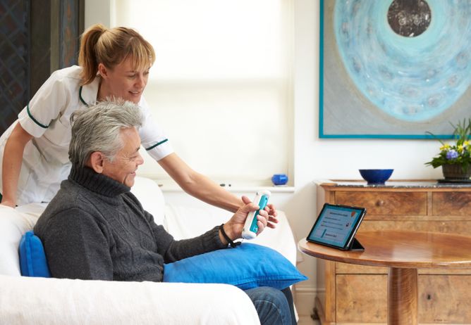 A healthcare professional working with a patient using the GripAble device