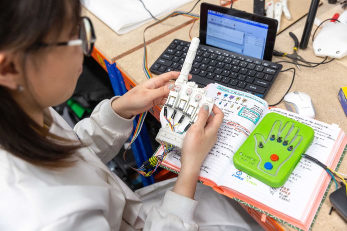 Design Engineering student with books and laptop doing creative things