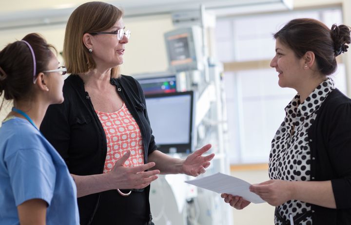 Professor Alison Holmes with two colleagues in the NIHR Health Protection Research Unit.