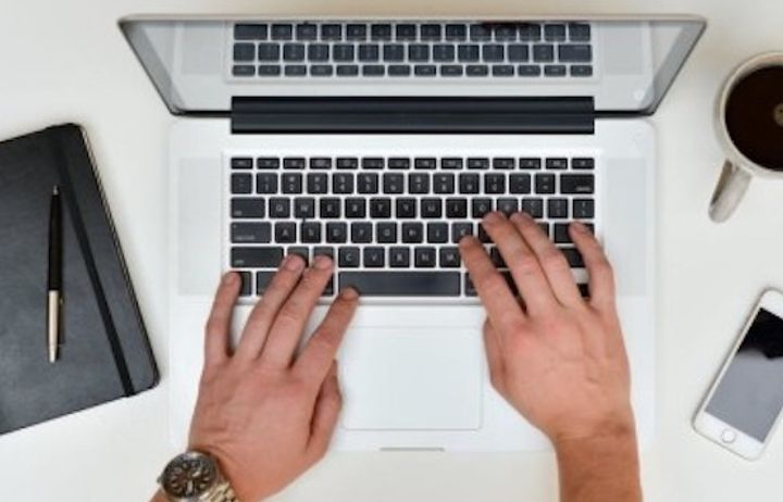 Hand typing on laptop