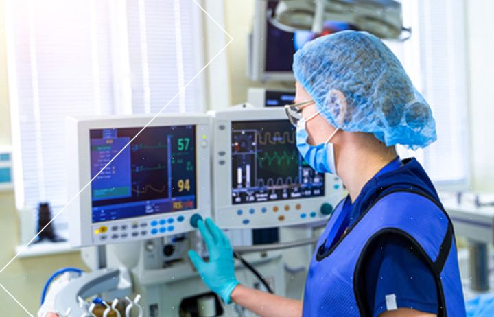 A nurse operating a ventilator