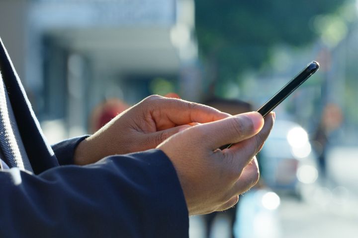 Closeup of hands, person using a smartphone