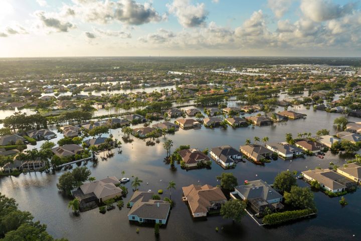 Aerial view of rows of houses in floodwater following a tropical storm