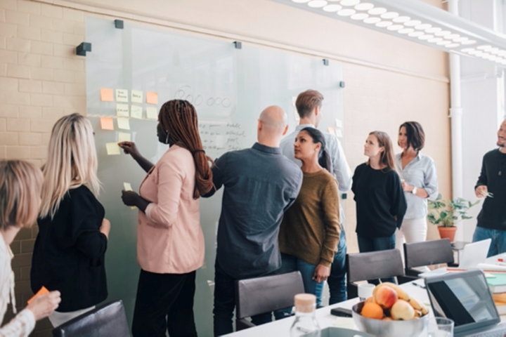 A group of people working on whiteboard