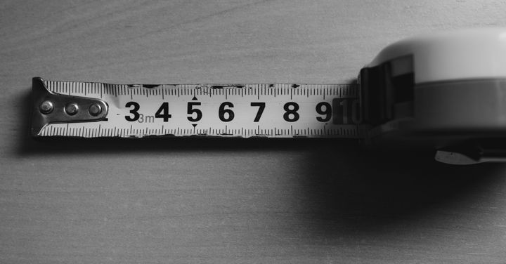 A close up shot of a table meaure being extended, here featured in black and white photography