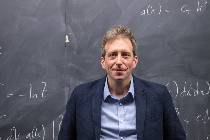 Physics professor standing in front of a blackboard