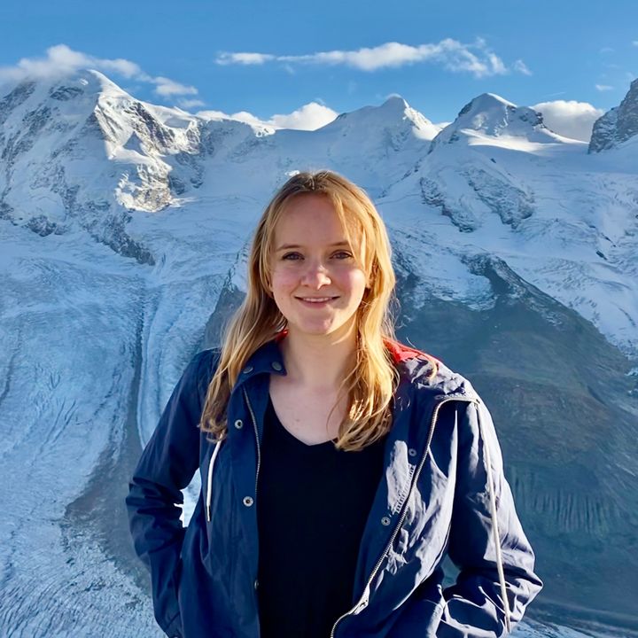 A female student stood in front of snowy mountains