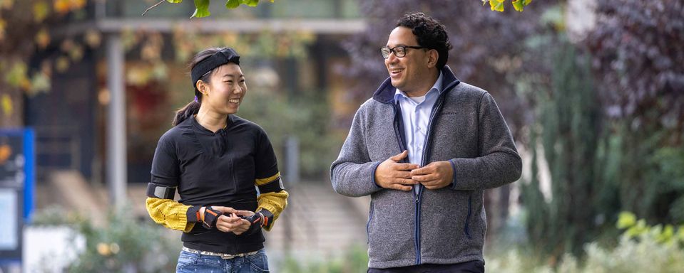 Aldo Faisal and Luchen Li, wearing a motion sensor suit and walking across the Queen's Lawn