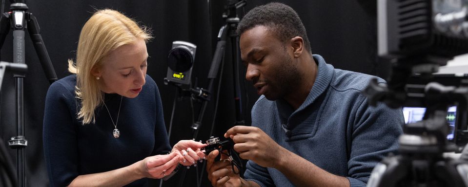 Dr Angela Kedgley and Lobby Akinnola adjust equipment in a biomechanics laboratory