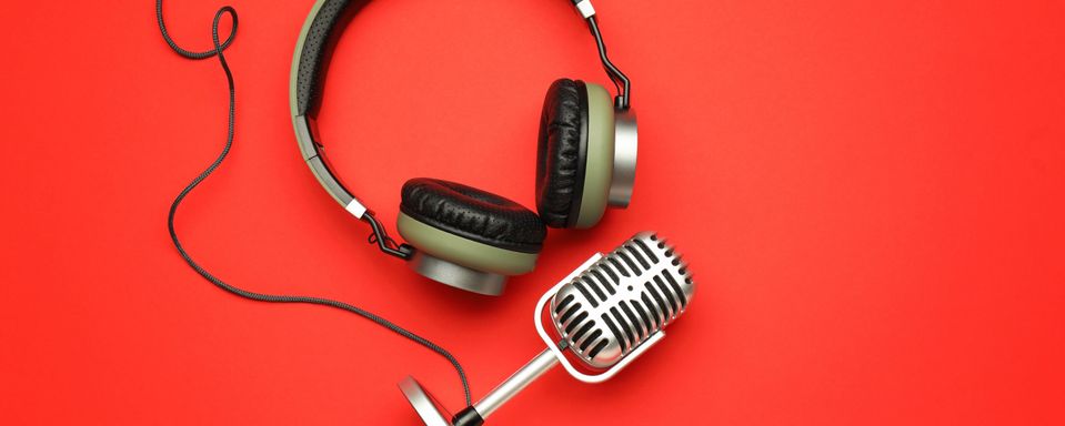 Headphones and microphone on a red background