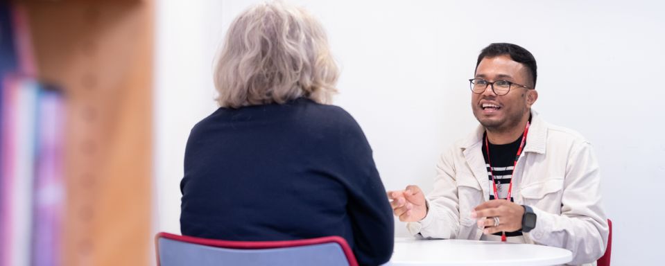 A student and a teacher having a one-to-one discussion