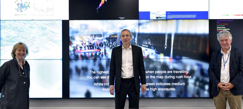 Three people in front of screen