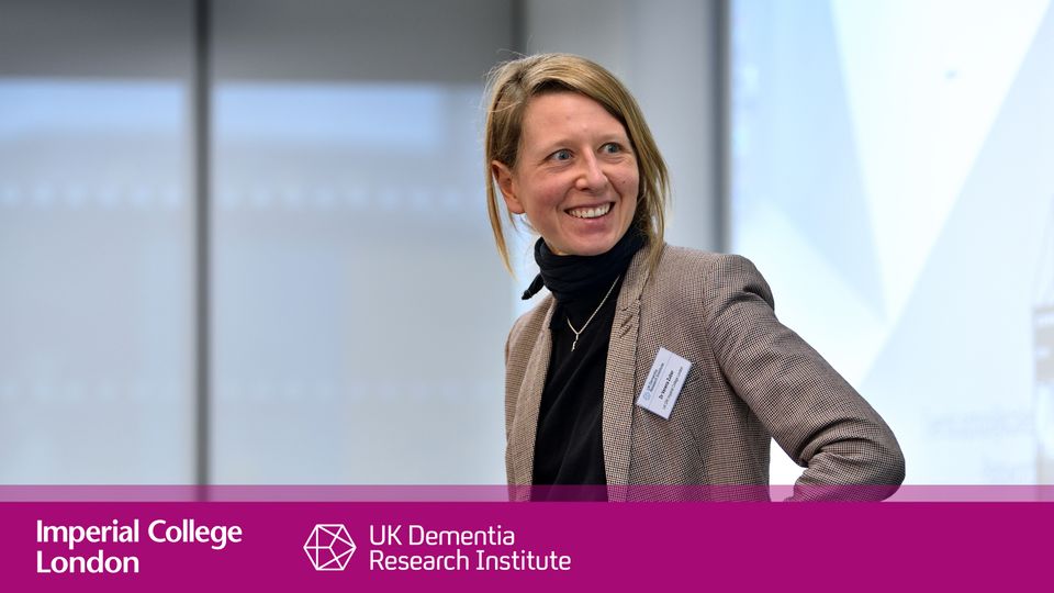 Verena Zuber stands at front of conference theatre smiling