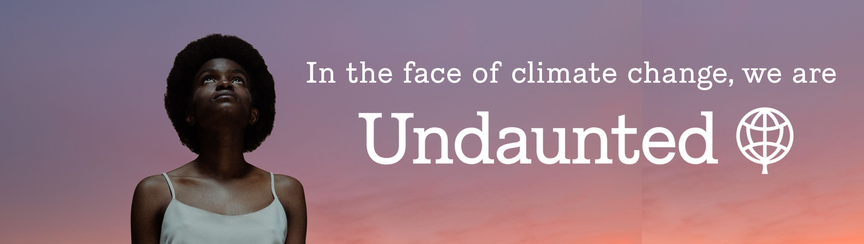 A woman looks up toward a purple sky with the text: In the face of climate change, we are Undaunted