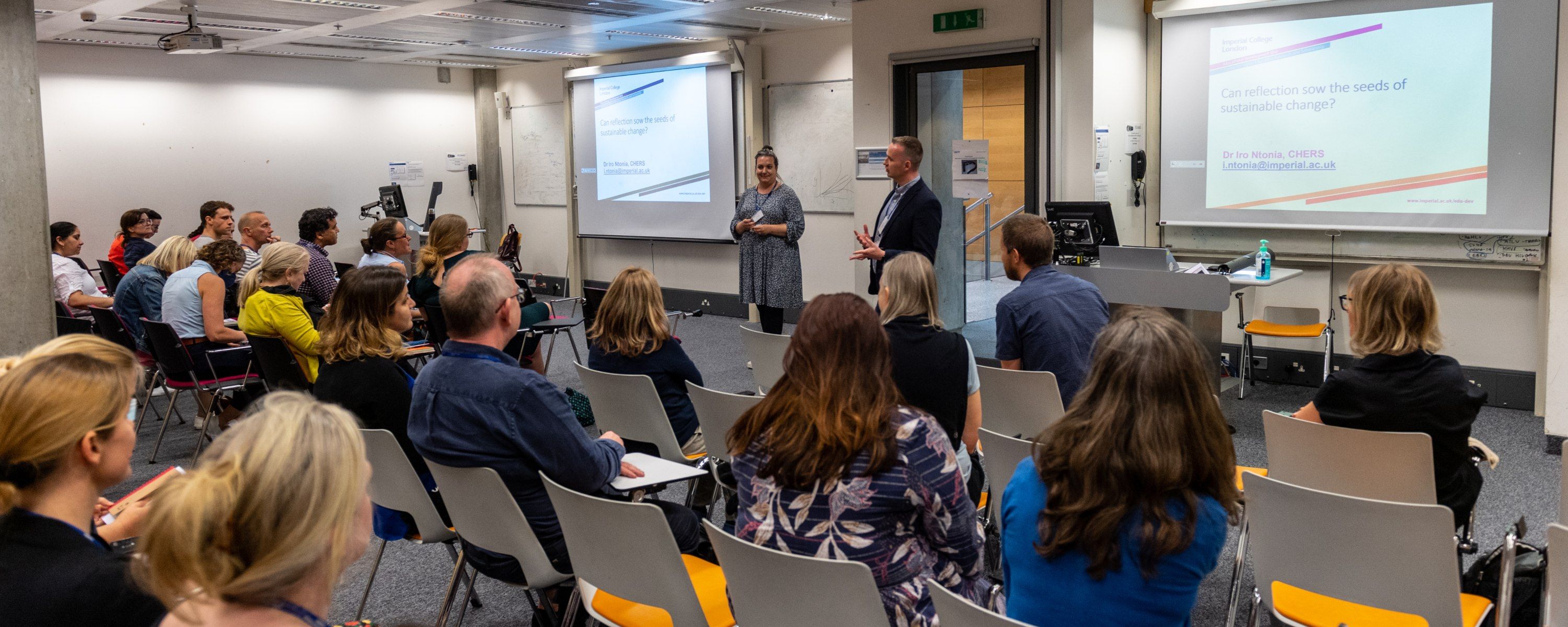 a classroom of staff listening to a presentation