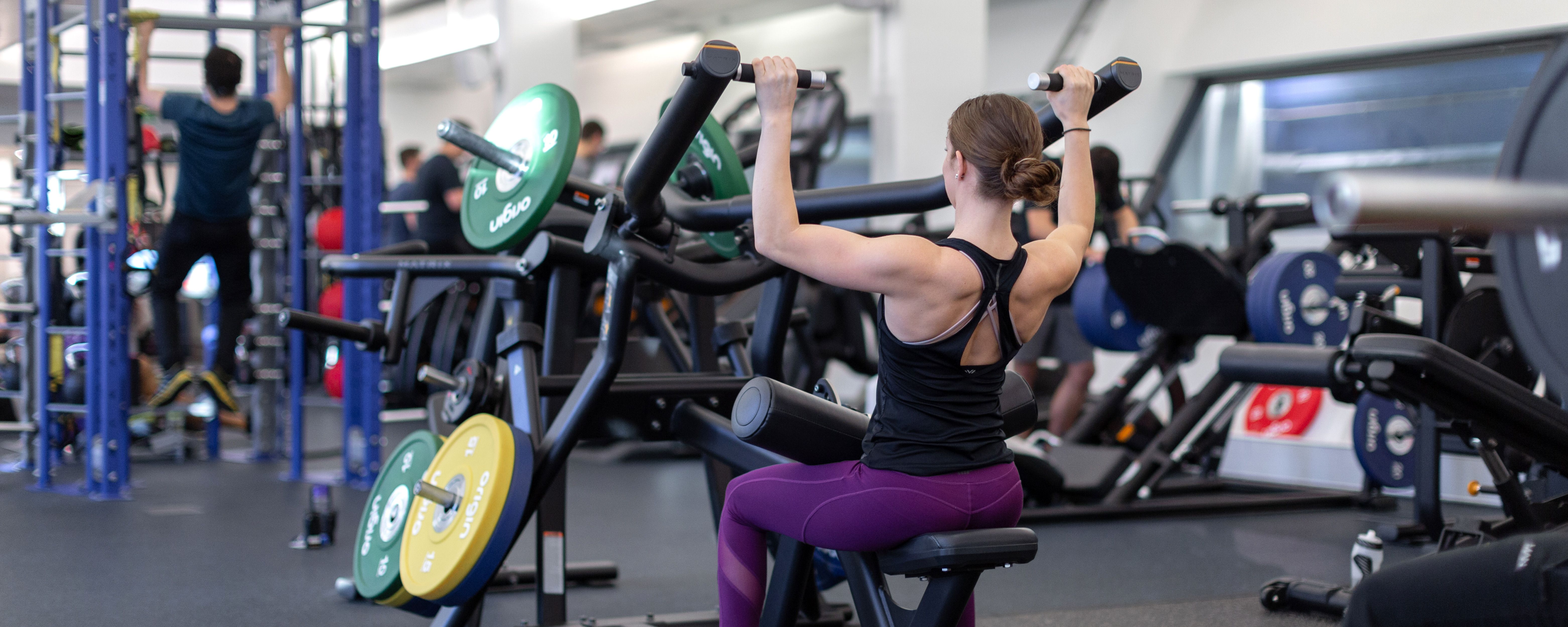 Woman lifting weights at Ethos gym