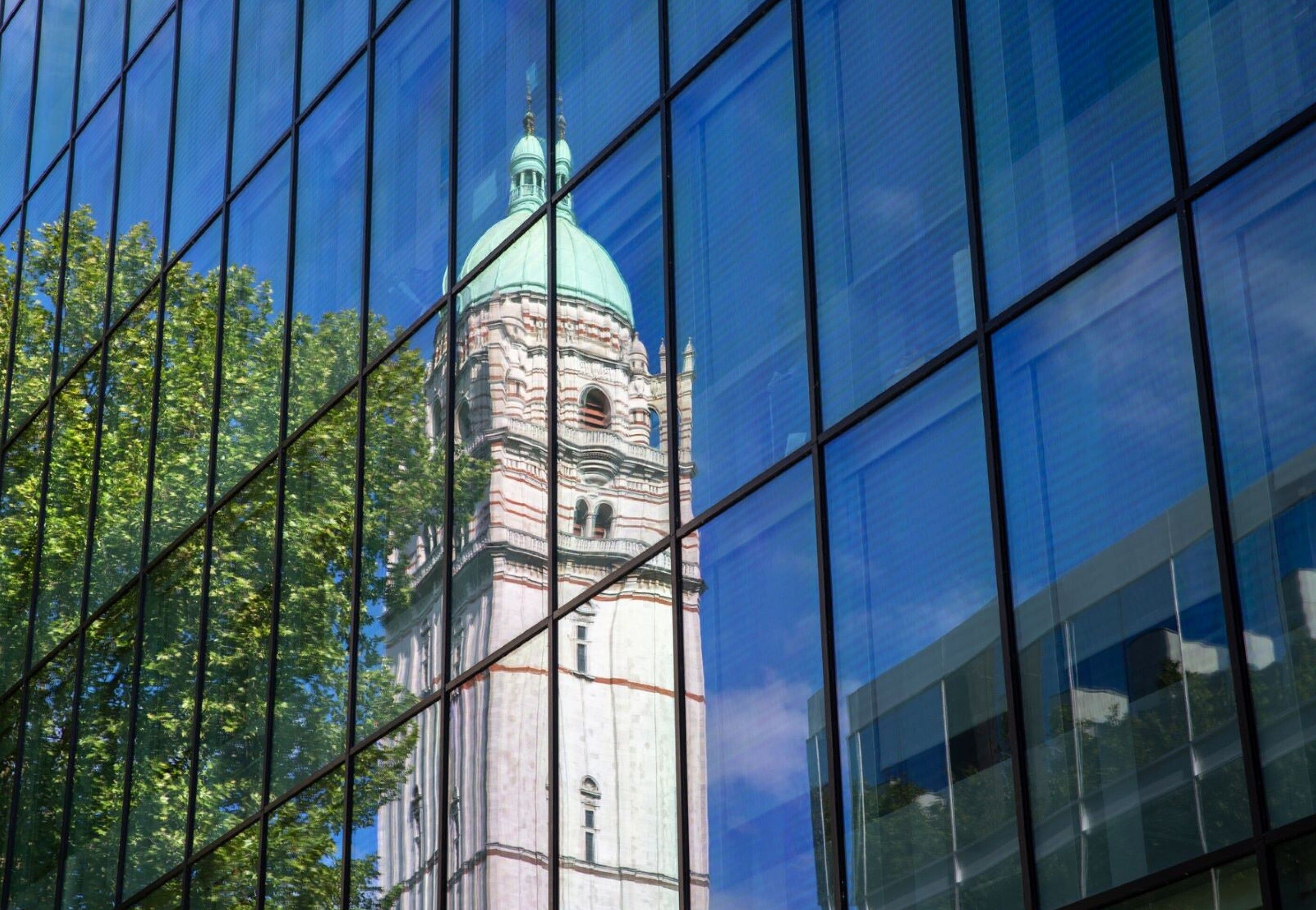 The Queen's Tower reflected in building windows